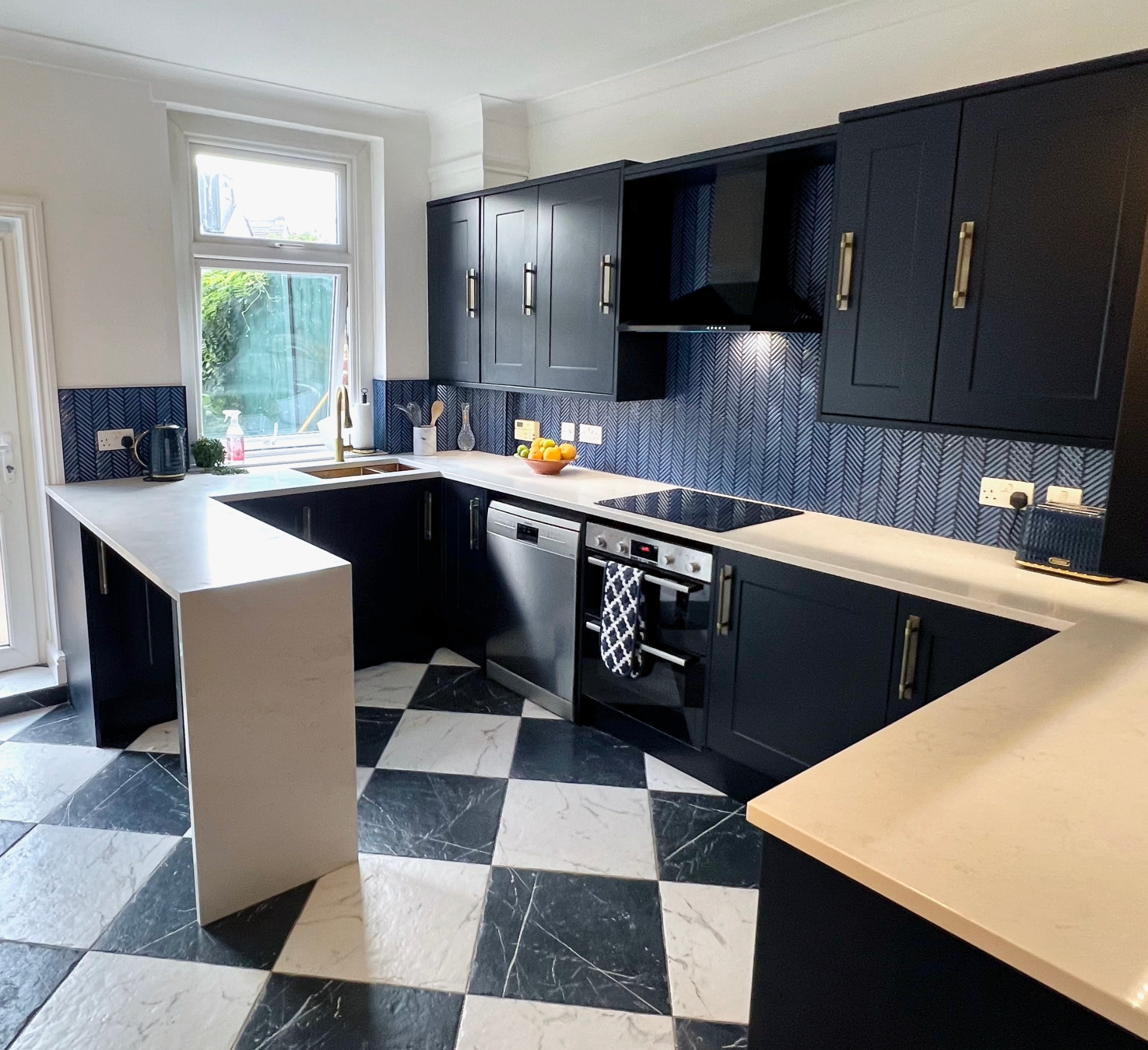 Midnight Navy Shaker — Herringbone splashback and brass detailing