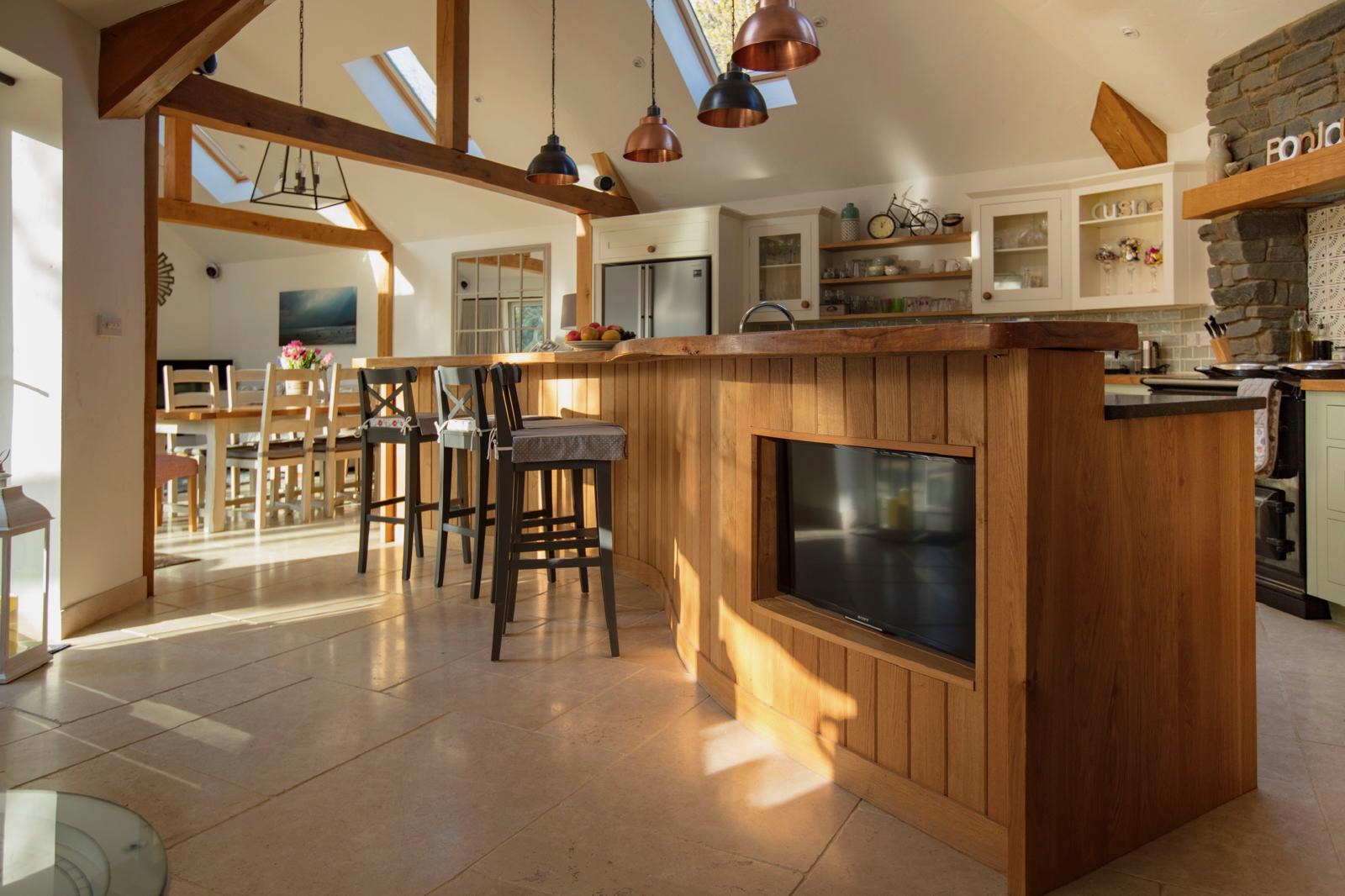 Bespoke Oak & Island Living — Integrated island with copper pendants
